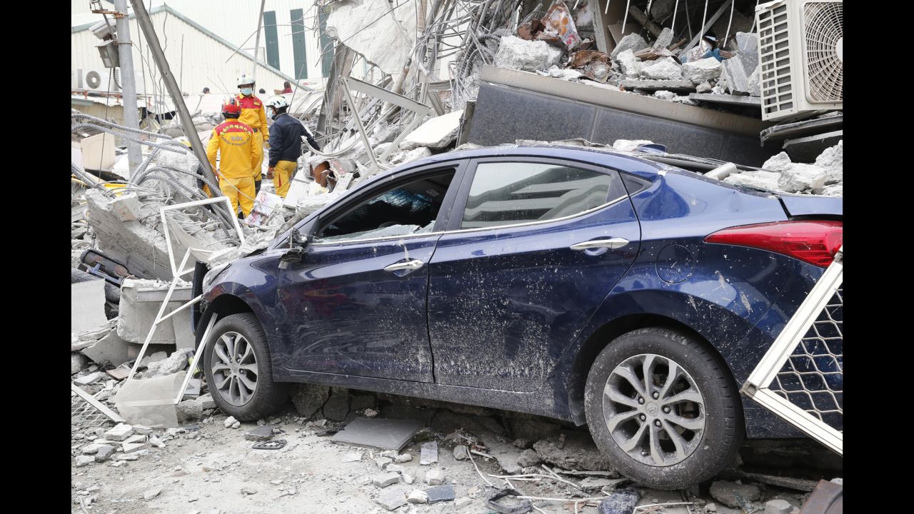 Rescue workers search a collapsed building in Tainan.