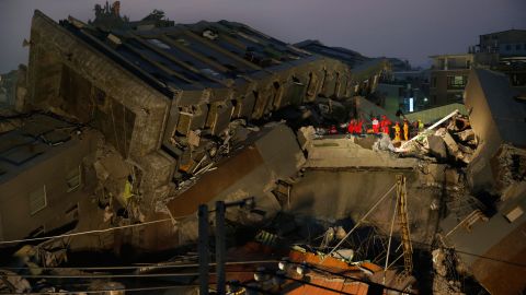 Rescue teams search the collapsed building in Tainan.