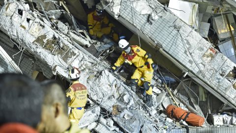 Rescue personnel work at the site of a collapsed building in Tainan.
