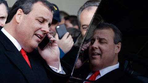 Republican presidential candidate New Jersey Gov. Chris Christie is reflected in his car's window after a campaign event on February 6, in Bedford, New Hampshire. 