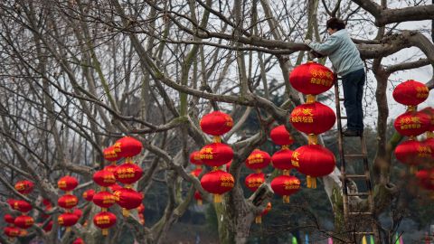 A worker decorates trees with red lanterns in a park in Changzhou, China, on February 4. 