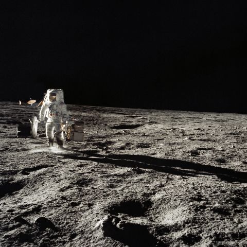 Bean carries equipment on the moon during the Apollo 12 mission.