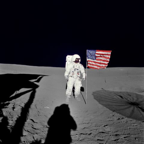Mitchell stands by the U.S. flag during his mission's first spacewalk. 