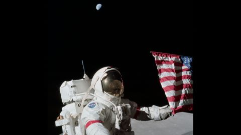 Cernan holds a corner of the American flag during the first Apollo 17 moonwalk. Cernan, the last man on the moon, had these parting words as he left: "We leave as we came and, God willing, as we shall return -- with peace, and hope for all mankind."