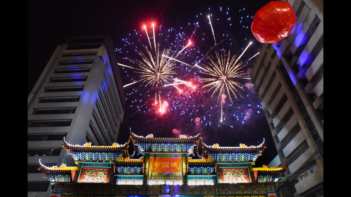 Fireworks celebrating the Lunar New Year illuminate the sky above the Chinatown friendship arch in Manila on Sunday, February 7. 