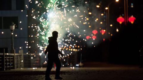 A man sets off fireworks near the Yalu River in Dandong, China, on February 7.