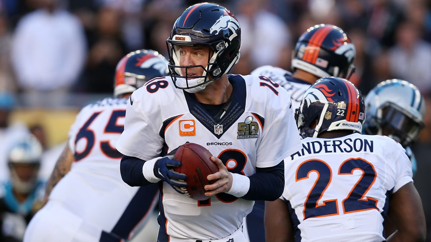 Manning looks to hand the ball off in the first quarter.