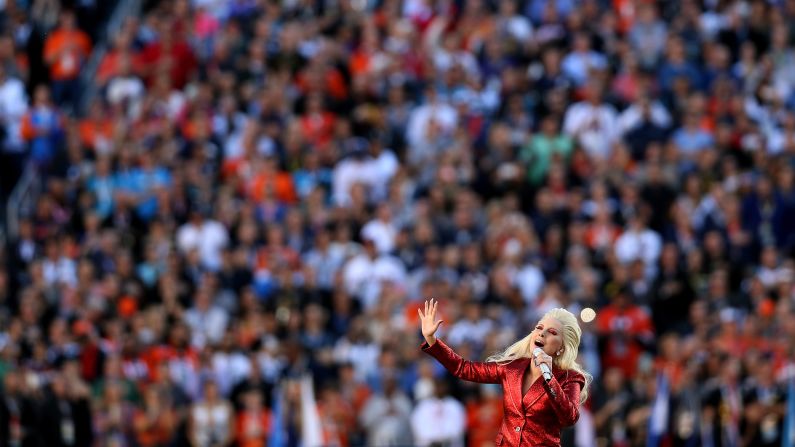 Lady Gaga performs the national anthem before the start of the game.