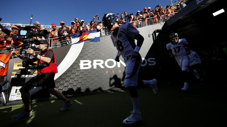 Manning and the Broncos take the field.