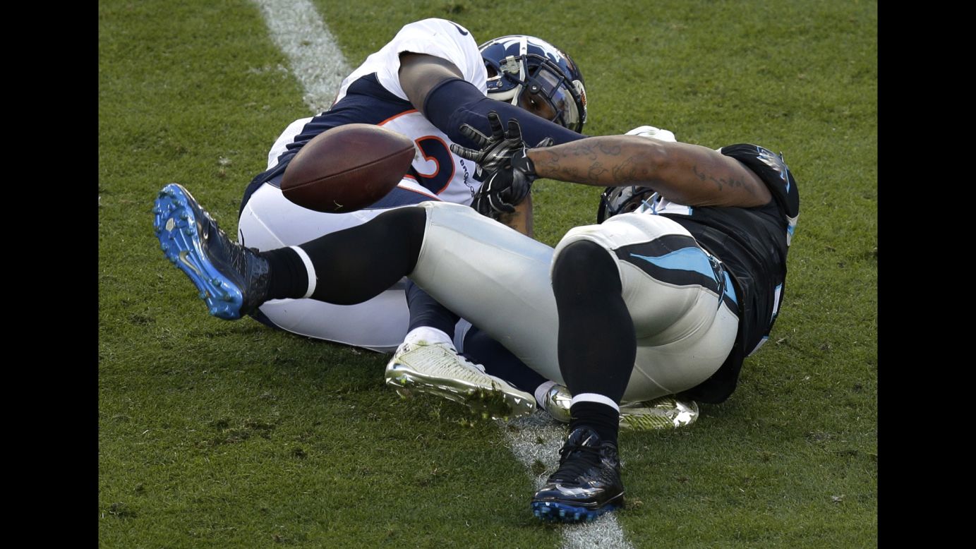 Tolbert fumbles in the first half as he is hit by the Broncos' Darian Stewart, left.