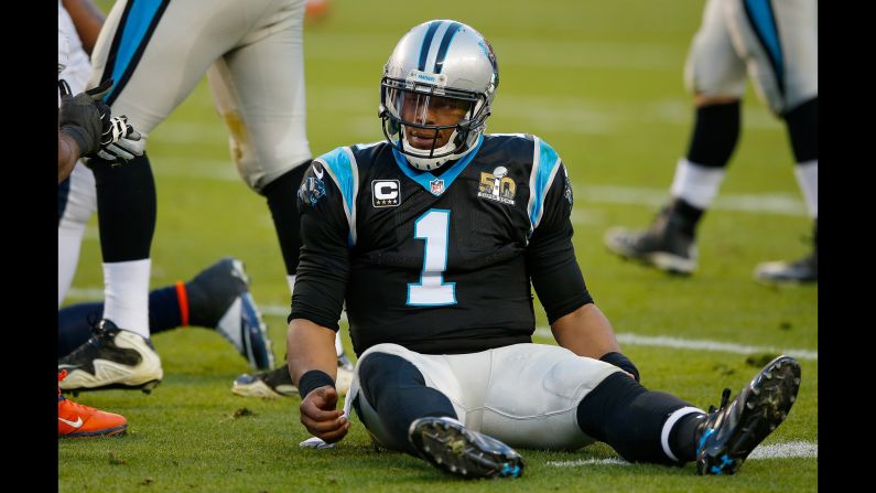 Newton sits on the turf after being hit in the first half. At halftime, Carolina trailed Denver 13-7.