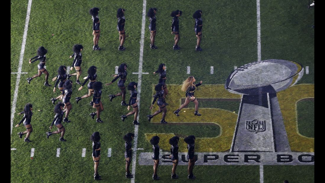 Beyonce and her dancers perform on the field.