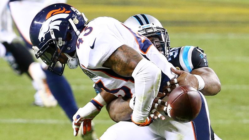 Carolina fullback Mike Tolbert strips the ball from Ward after Ward intercepted a pass in the third quarter. Denver recovered the ball.