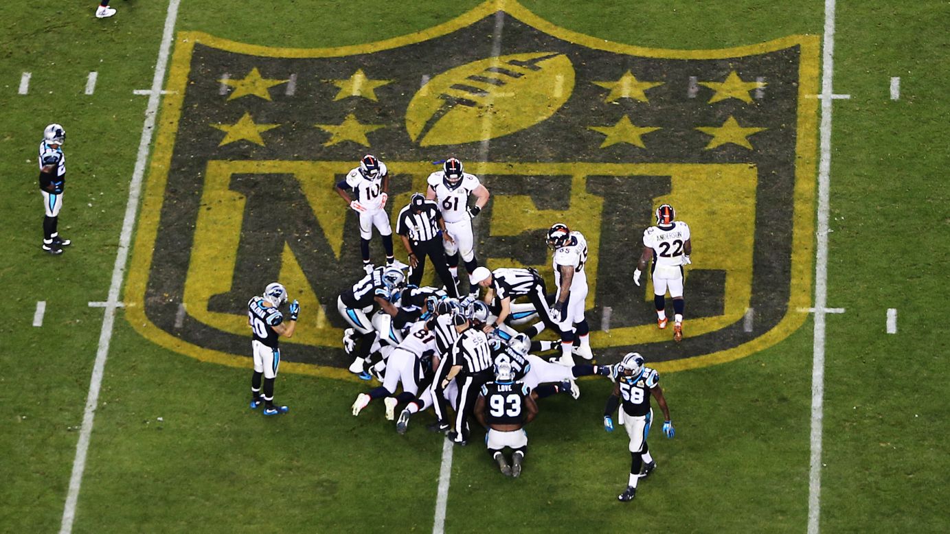 Denver and Carolina players attempt to recover a Manning fumble in the fourth quarter.