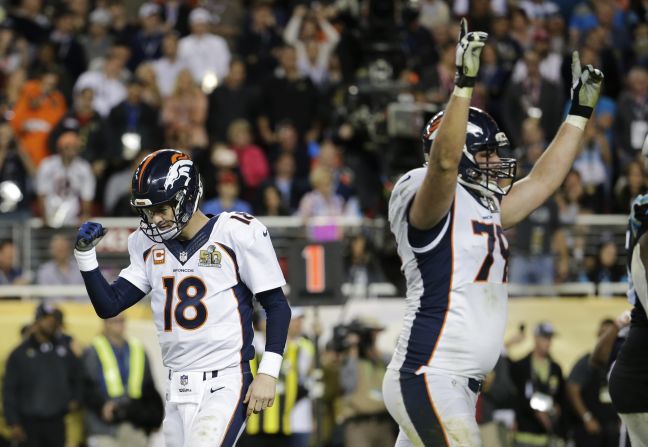 Manning and teammate Michael Schofield celebrate C.J. Anderson's touchdown in the second half.