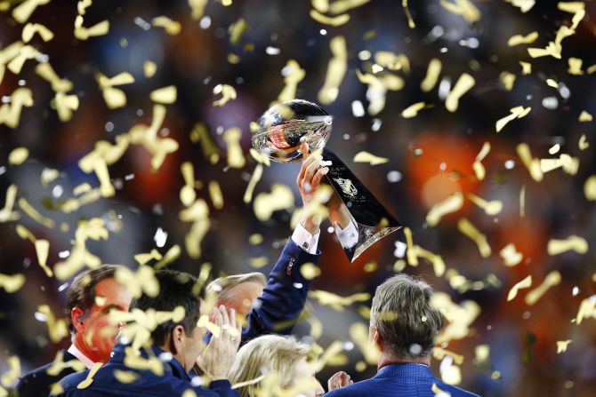 The Vince Lombardi Trophy is held up by Broncos general manager John Elway after the game. Elway also won two Super Bowls as a Broncos quarterback.