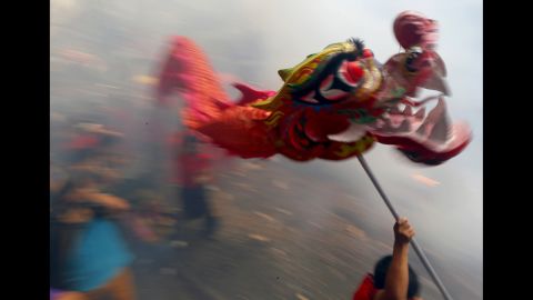 Dancers perform amid exploding firecrackers in Manila, Philippines, on February 8.