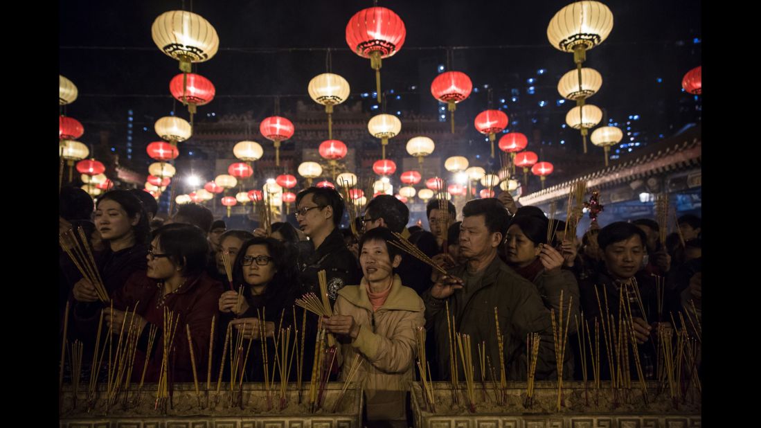 People pray and burn joss sticks at the Wong Tai Sin Temple in Hong Kong on February 8.