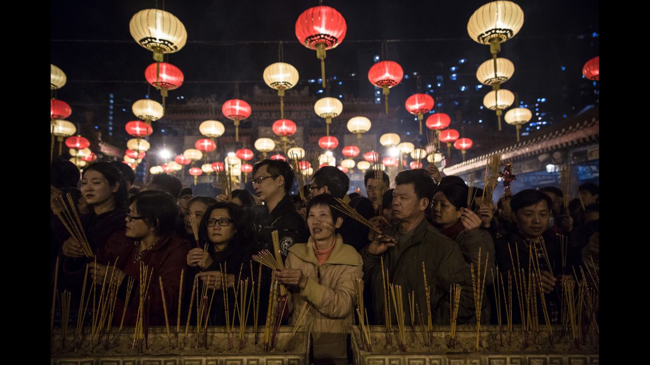People pray and burn joss sticks at the Wong Tai Sin Temple in Hong Kong on February 8.