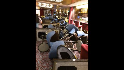 The storm flipped over chairs and tables aboard the Anthem of the Seas. Four people were injured, the cruise line said, but none seriously.