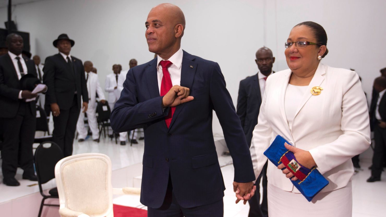 Michel Martelly, Haiti's outgoing President, stands with his wife, Sophia, before they leave parliament chambers in Port-au-Prince on Sunday.  