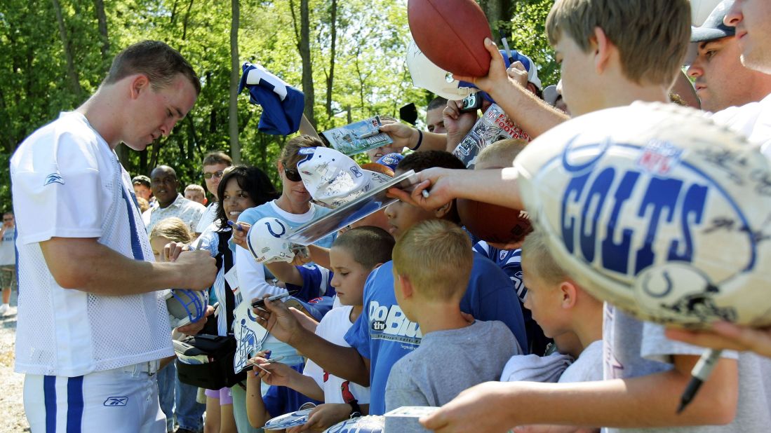 Manning signs autographs for fans during training camp in 2005.