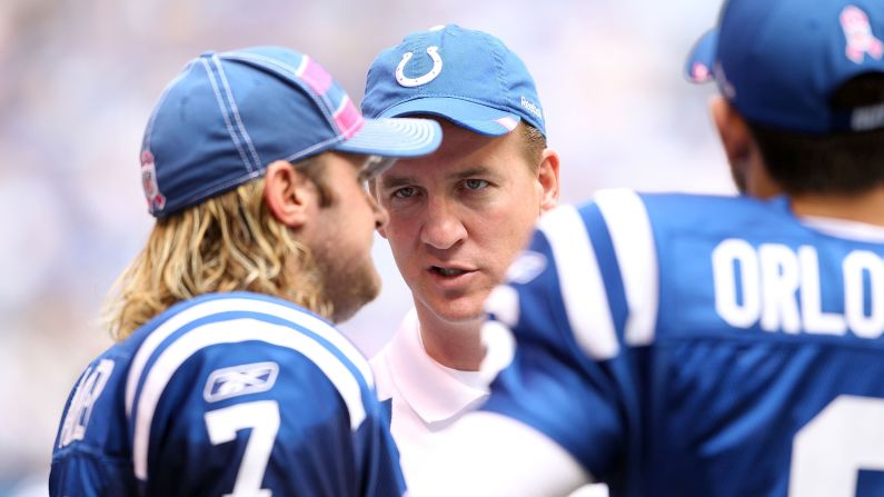 Manning talks to Colts teammate Curtis Painter during a game in 2011. Manning missed the entire season after undergoing surgery for a herniated disc in his neck.
