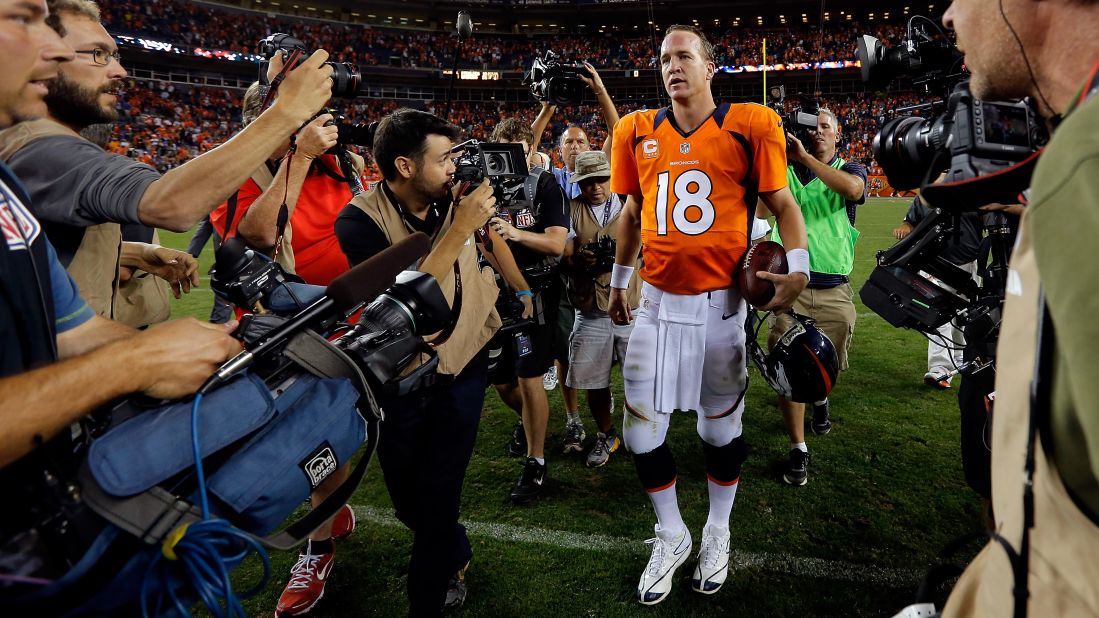 Manning walks off the field in 2012 after his first regular-season game as a Denver Bronco. He signed a five-year deal with the team after being released by the Colts.