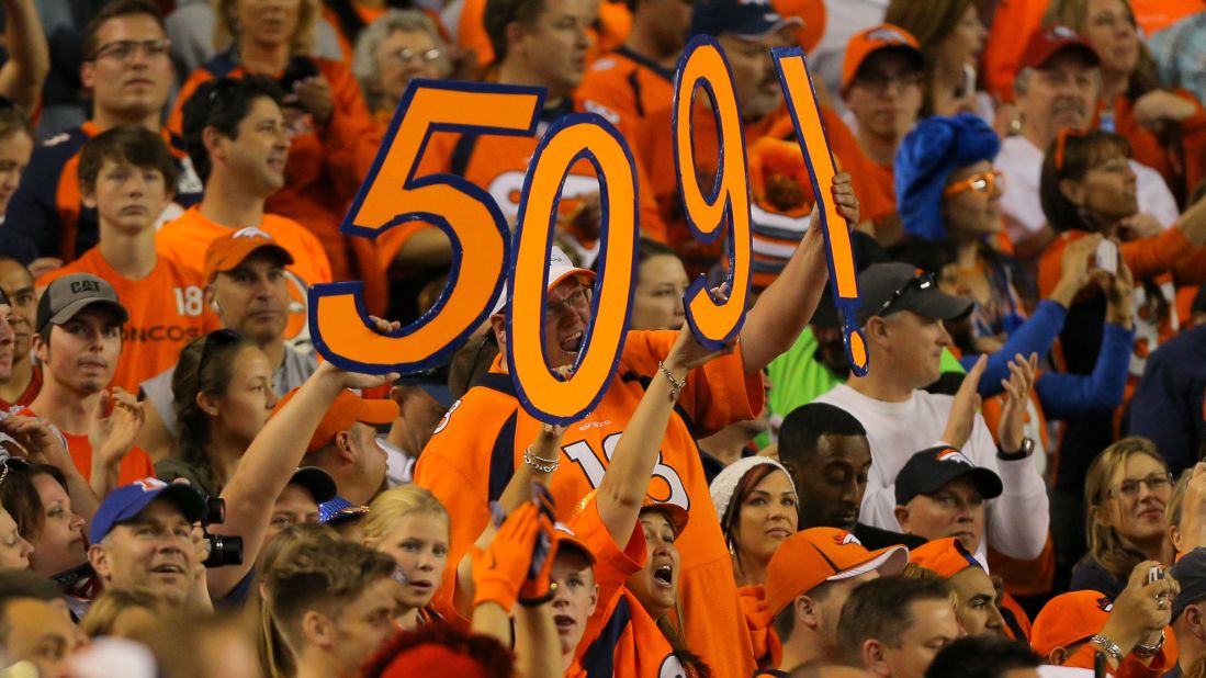 Denver fans celebrate in 2014 after Manning threw his 509th career touchdown pass, breaking the NFL record held by Brett Favre.