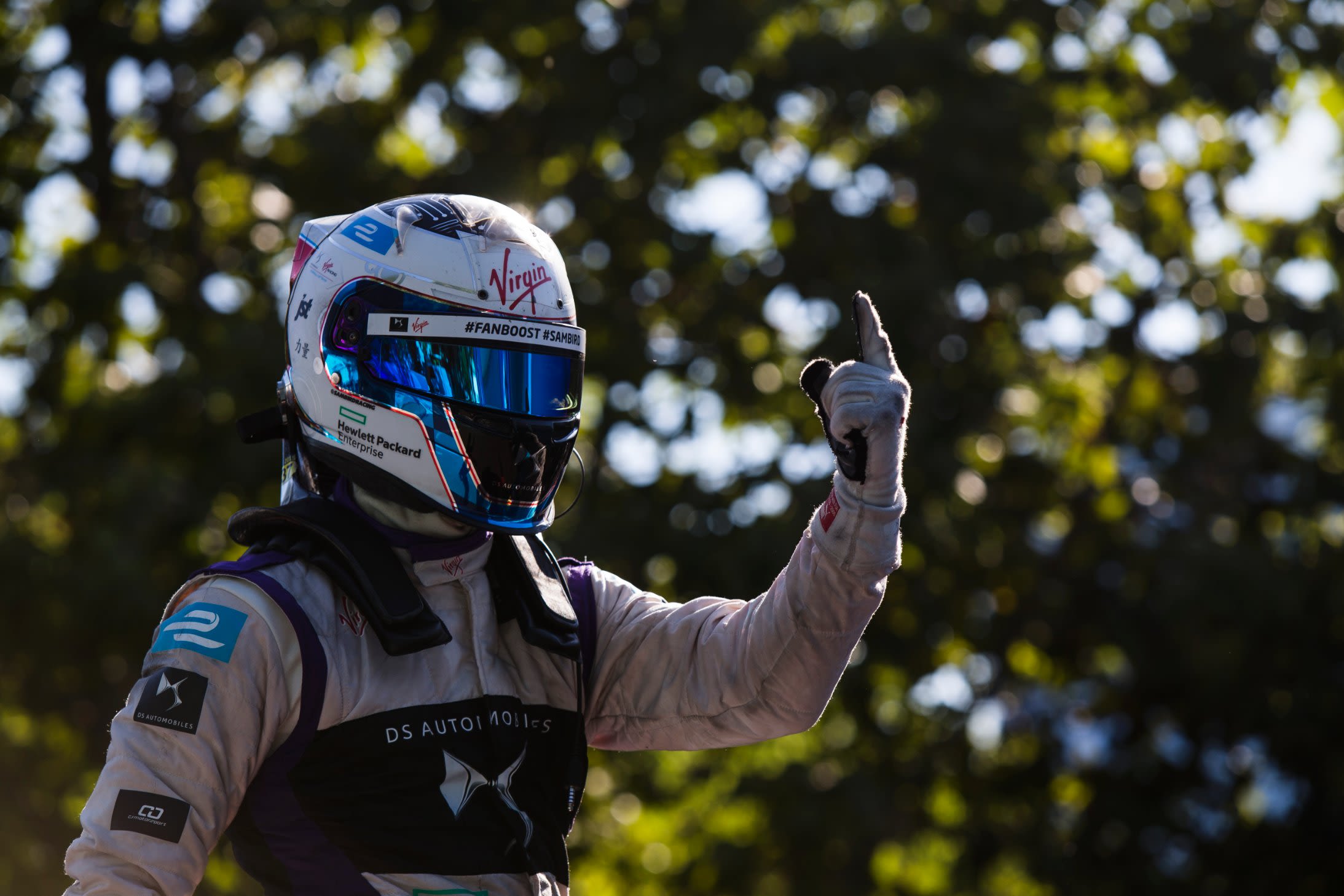 A joyous Sam Bird gives a one-fingered victory salute after the Formula E ePrix in Buenos Aires.