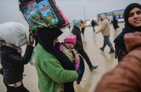 Refugees arrive near the Turkish border as they flee the city of Aleppo on February 6.
