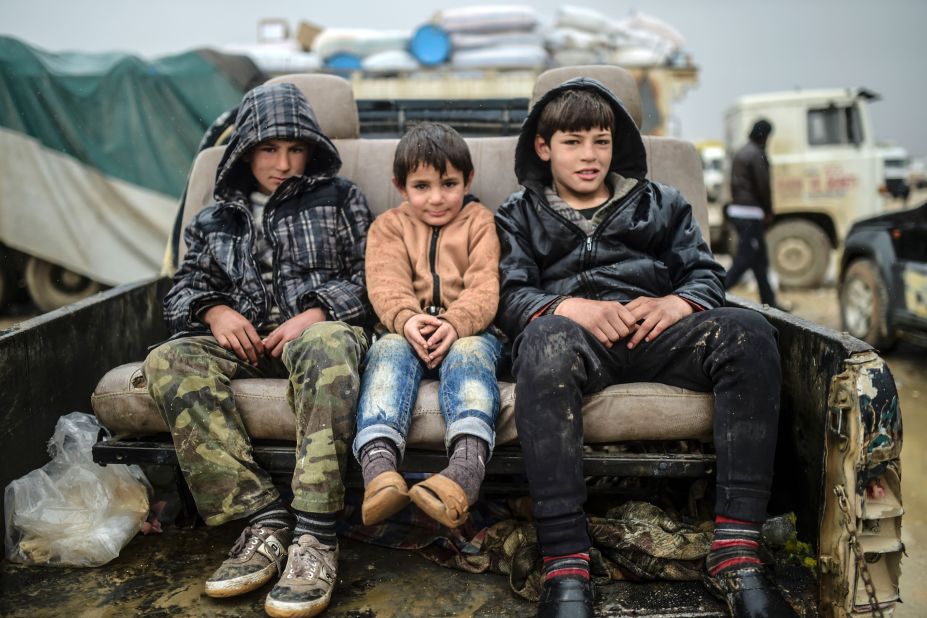 Refugee children sit on a car near the Turkish border crossing on February 6.