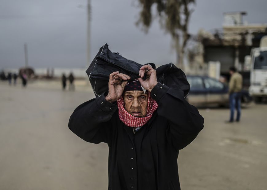 A refugee woman carries her belongings near the Turkish border gate on February 6.