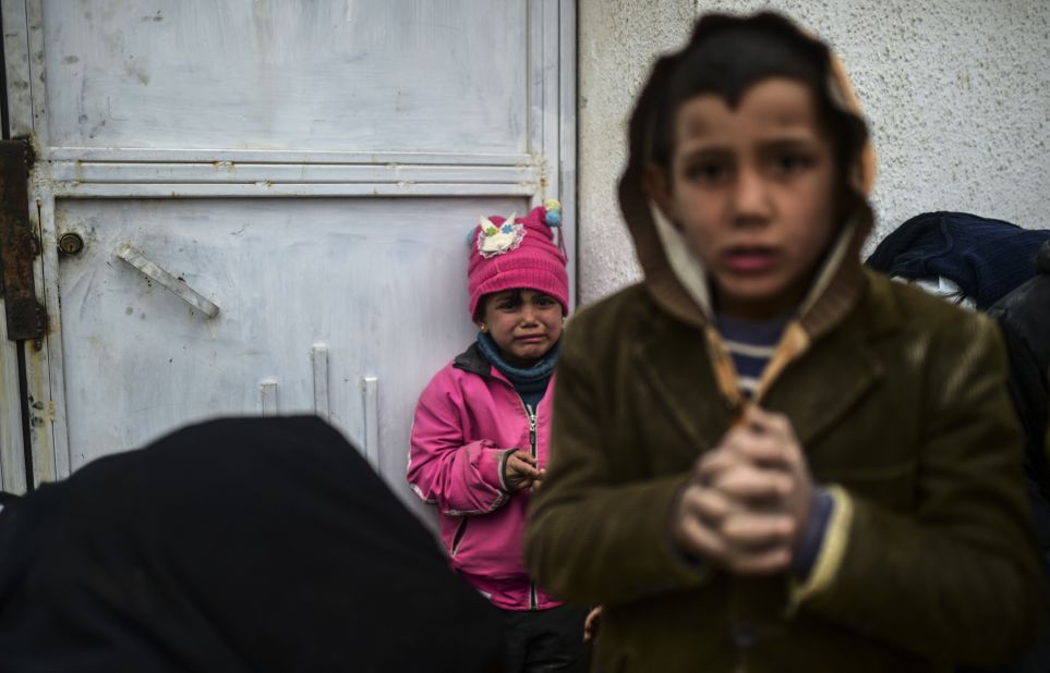 A refugee girl reacts near the Turkish border gate on February 6.