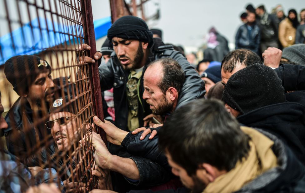 Refugees jostle one another for tents near the Turkish border on February 6.