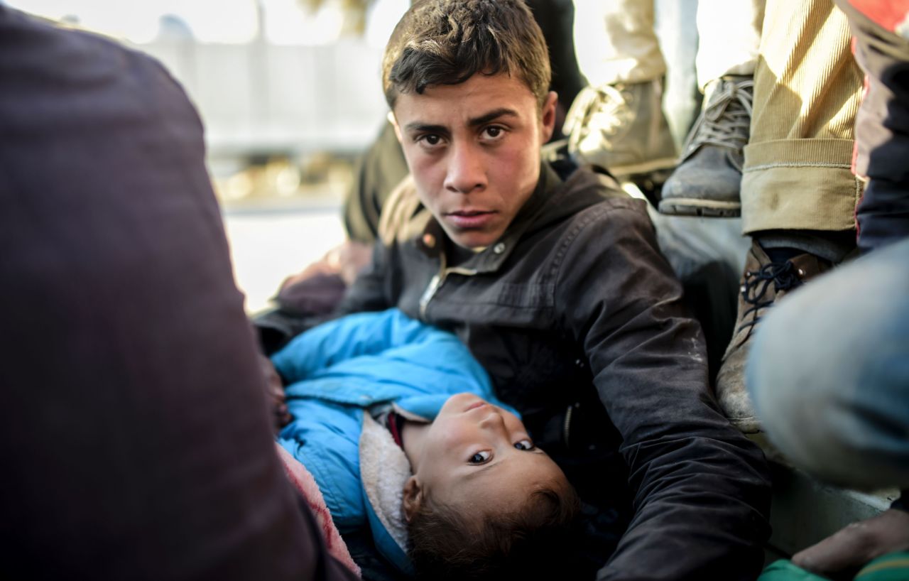 A Syrian teenager and a child look on near the Turkish border on February 5.