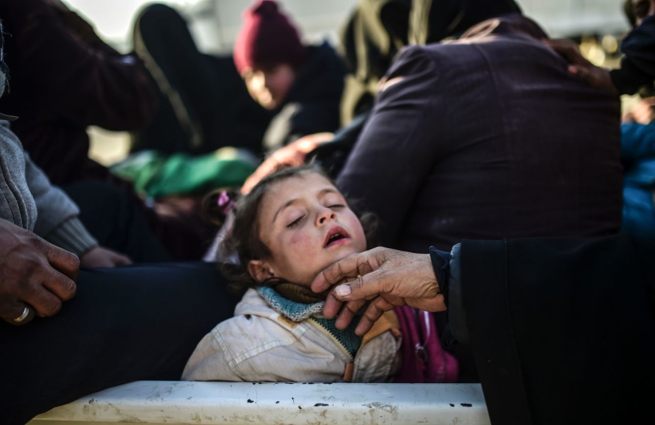 A child sleeps as Syrians fleeing the northern embattled city of Aleppo wait near the Turkish border on February 5, 2016.