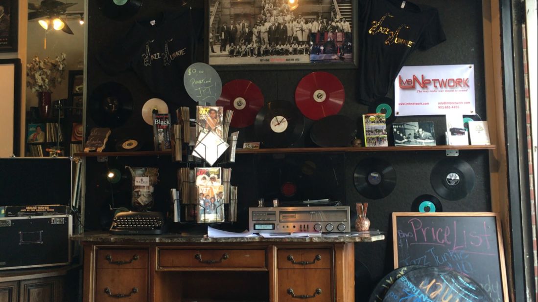The walls and shelves are decorated with old records and radio paraphernalia.