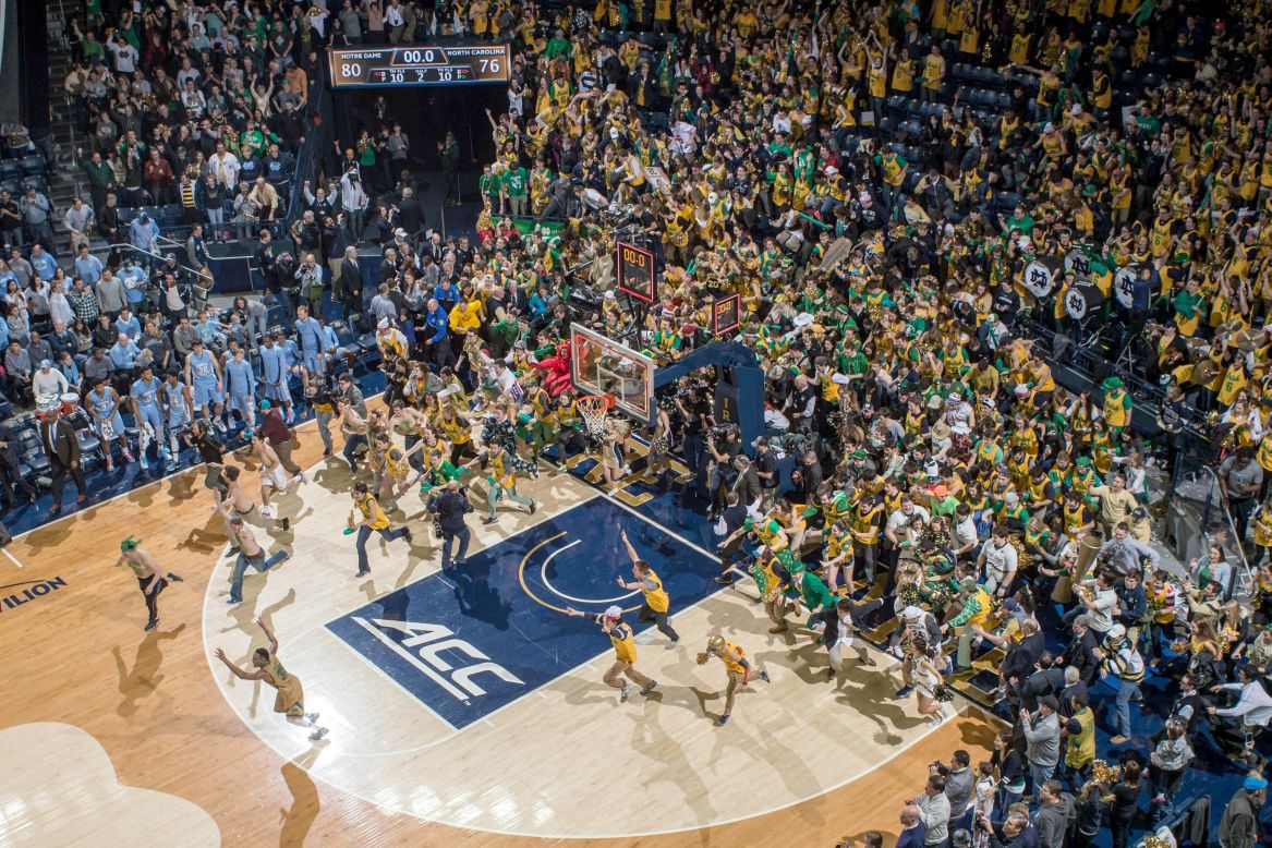 Notre Dame students storm their home court after the men's basketball team defeated No. 2 North Carolina on Saturday, February 6.