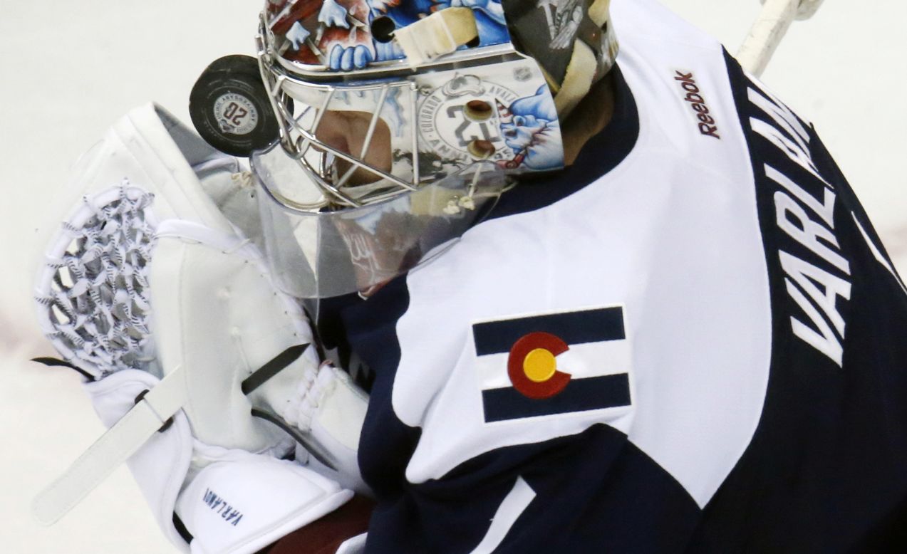 Colorado goalie Semyon Varlamov is hit in the mask with a puck as he tries to make a save during an NHL game in Denver on Saturday, February 6.