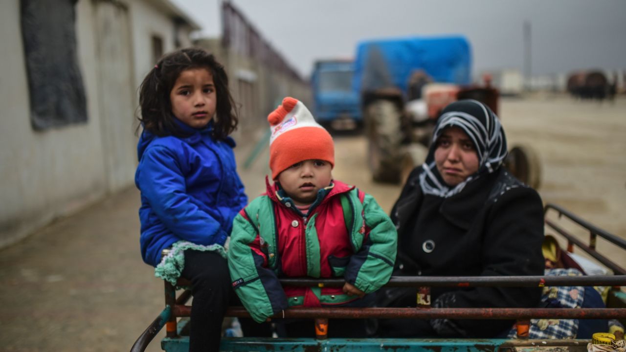 TOPSHOT - Refugee children arrive a the Turkish border crossing gate as Syrians fleeing the northern embattled city of Aleppo wait on February 6, 2016 in Bab al-Salama, near the city of Azaz, northern Syria.
Thousands of Syrians were braving cold and rain at the Turkish border Saturday after fleeing a Russian-backed regime offensive on Aleppo that threatens a fresh humanitarian disaster in the country's second city. Around 40,000 civilians have fled their homes over the regime offensive, according to the Syrian Observatory for Human Rights monitor. / AFP / BULENT KILIC (Photo credit should read BULENT KILIC/AFP/Getty Images)