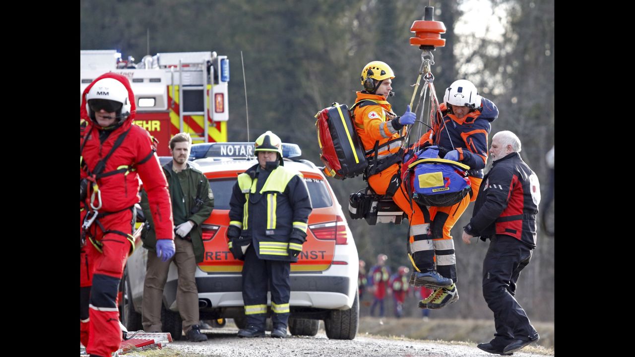 Rescue personnel are airlifted near the wreckage.