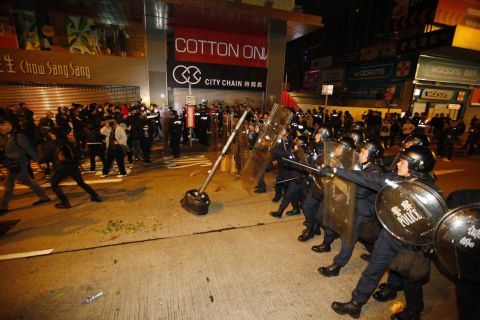 Riot police move forward to the protesters on a street in Hong Kong's Mong Kok district, Tuesday, February 9, 2016. 