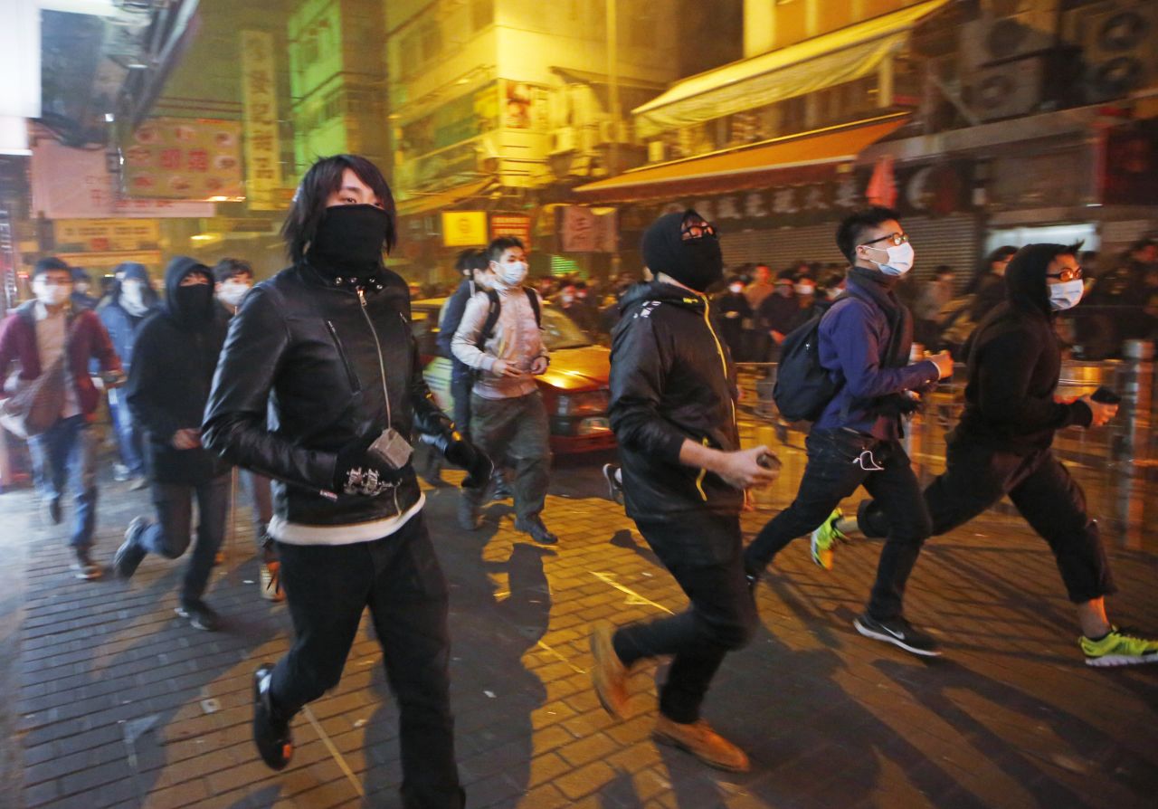 Rioters carry bricks along a street in Mong Kok in the early morning of February 9.
