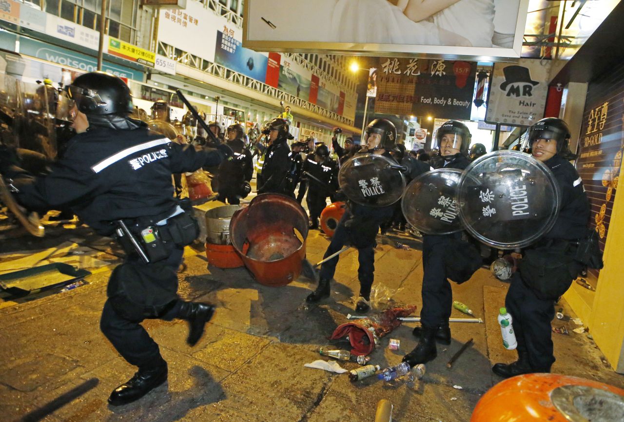 Riot police advance on protesters in a street in Mong Kok on February 9.
