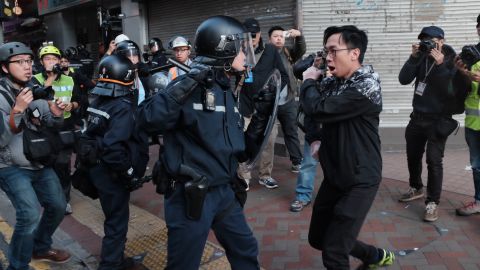 Riot police and a protester scuffle in a street in Mong Kok on February 9.