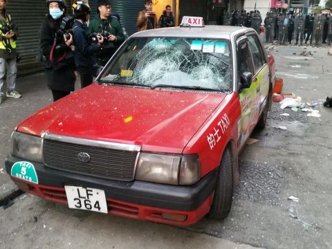 The windshield of a taxi is smashed by bricks on February 9.
