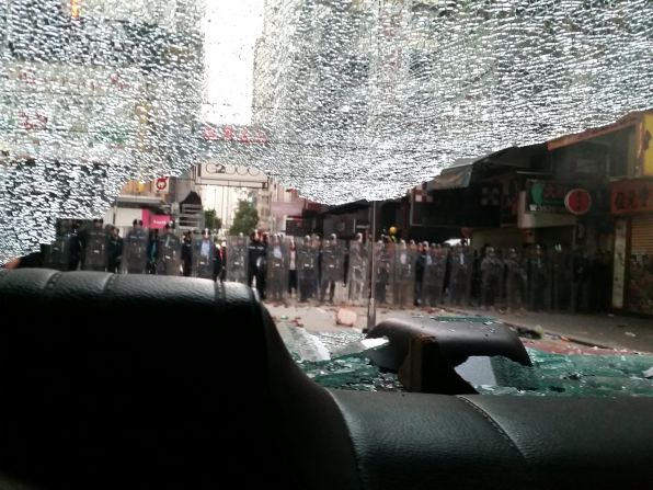 A view of riot police through the smashed windshield of a taxi, pictured on February 9.