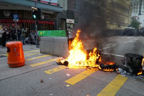 Fires were lit in trash bins as protesters faced off with riot police.