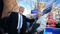 Republican presidential candidate Donald Trump greets people as he visits a polling station as voters cast their primary day ballots on February 9, 2016 in Manchester, New Hampshire.